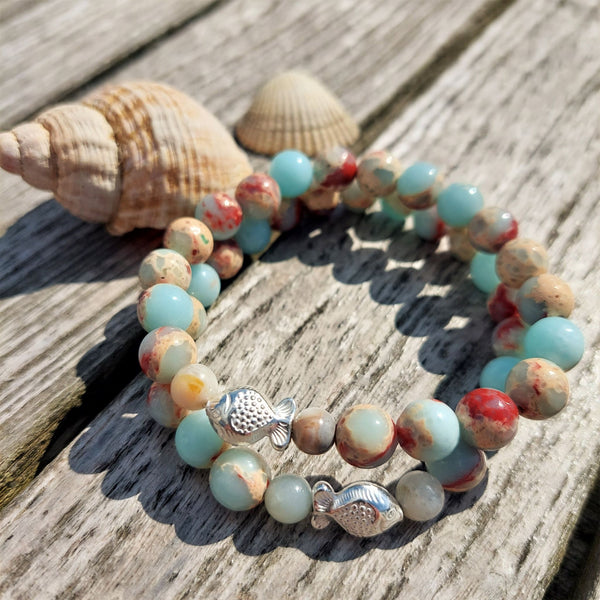 Gorgeous natural stone bead bracelet in shades of pale blue, cream & brown with super cute sterling silver fish  Elasticated, so will fit most adult wrists (measuring 71/2 in/19cm)  Add a cool beach vibe look to your outfit with these natural stone bracelets  **Presented in lovely Kraft paper gift box with reusable organza pouch**