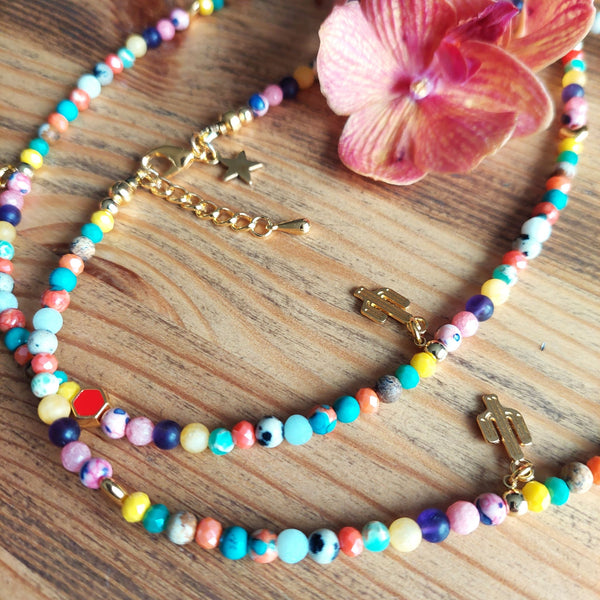 Lovely short necklace in multi colours with cute gold plated cactus & heart charms. Handmade using agate, dalmatian jasper, natural stone & gold plated hematite beads.  Gold plated fastenings & lobster clasp with gold (nickel free) star charm  Length - 40cm with extension chain to 43cm  Perfect for wearing with all your favourite Tees!