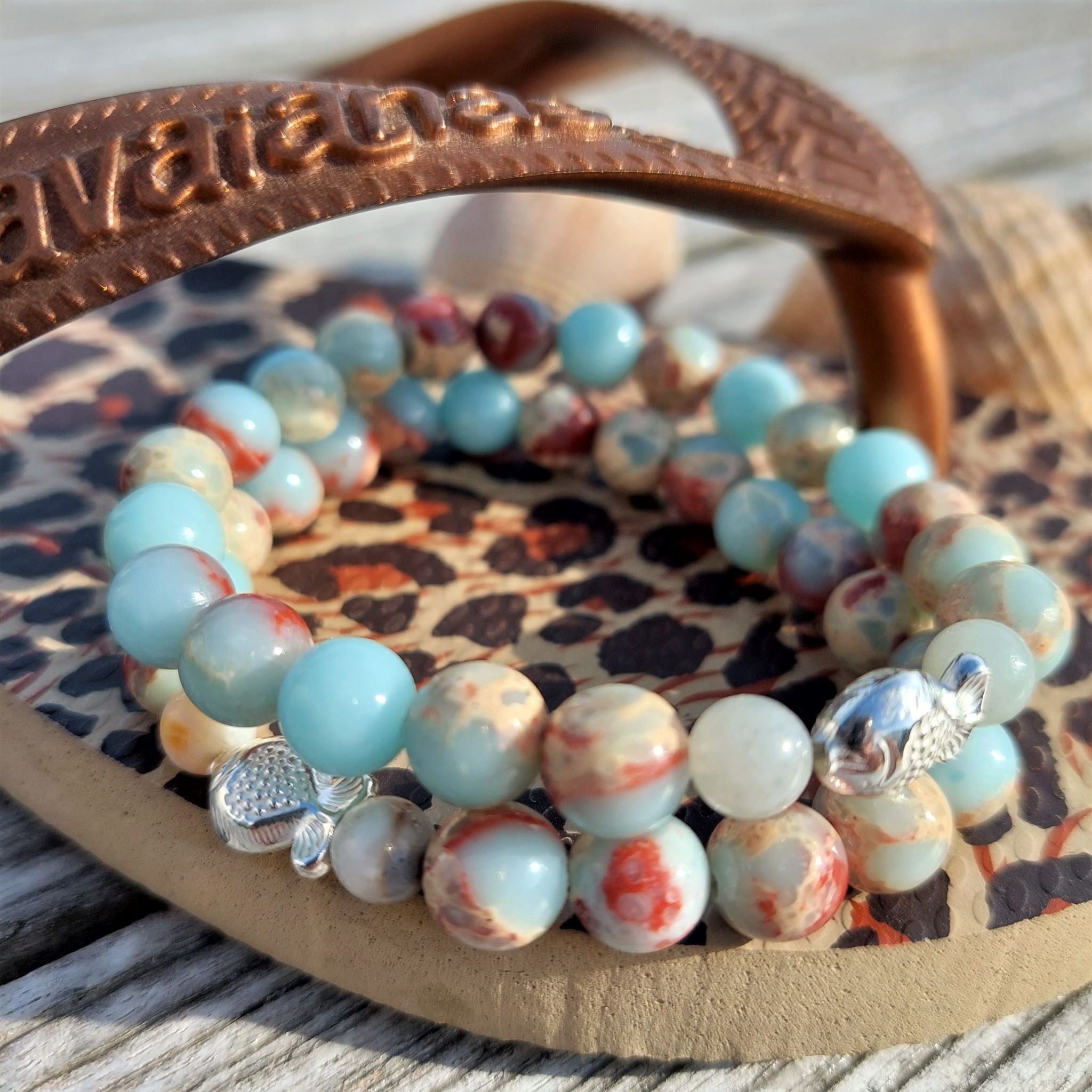 Gorgeous natural stone bead bracelet in shades of pale blue, cream & brown with super cute sterling silver fish  Elasticated, so will fit most adult wrists (measuring 71/2 in/19cm)  Add a cool beach vibe look to your outfit with these natural stone bracelets  **Presented in lovely Kraft paper gift box with reusable organza pouch**