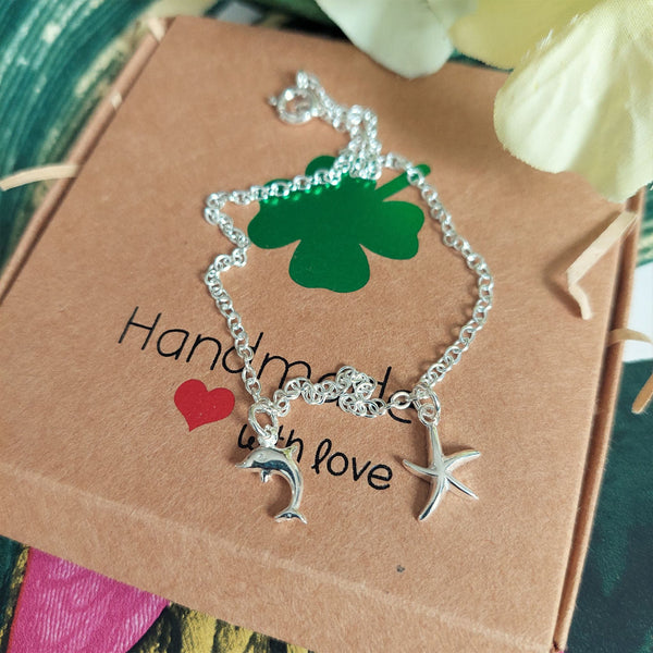 ﻿925 Hall marked Sterling Silver  Sterling Silver recycled trace chain Anklet with cute starfish & dolphin charms  One length available - 24cm  Perfect to stack with beaded anklets or alone for a beachy look!  ﻿**Presented in lovely Kraft paper gift box with reusable organza pouch**
