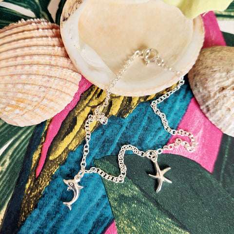 ﻿925 Hall marked Sterling Silver  Sterling Silver recycled trace chain Anklet with cute starfish & dolphin charms  One length available - 24cm  Perfect to stack with beaded anklets or alone for a beachy look!  ﻿**Presented in lovely Kraft paper gift box with reusable organza pouch**