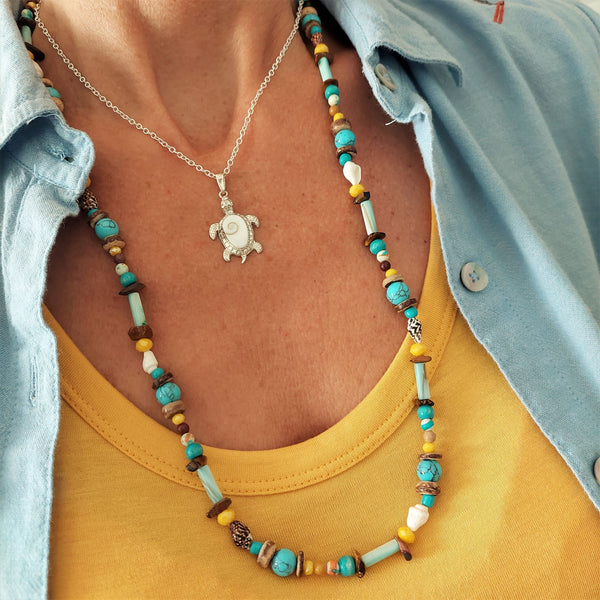 A super cool long bead surf necklace in lovely blue, yellow & brown colours. A Perfect addition to all your Summer outfits.  A combination of natural stone, shell, calcite, wood & silver hematite beads   Silver plated fastenings & clasp with silver (nickel free) 'made with love' heart & little turtle charm  length 74cm  Gift wrapped & presented in a pretty organza pouch