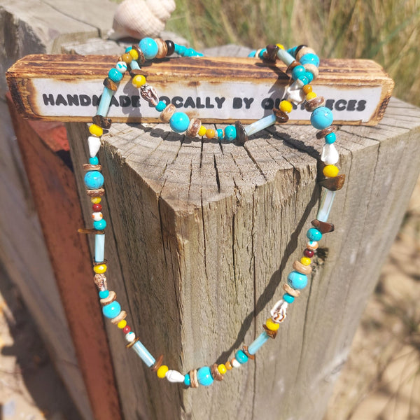 A super cool long bead surf necklace in lovely blue, yellow & brown colours. A Perfect addition to all your Summer outfits. A combination of natural stone, shell, calcite, wood & silver hematite beads Silver plated fastenings & clasp with silver (nickel free) 'made with love' heart & little turtle charm length 74cm Gift wrapped & presented in a pretty organza pouch