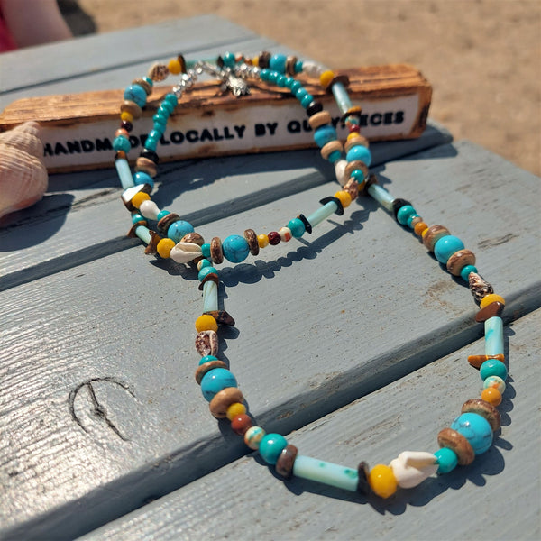 A super cool long bead surf necklace in lovely blue, yellow & brown colours. A Perfect addition to all your Summer outfits. A combination of natural stone, shell, calcite, wood & silver hematite beads Silver plated fastenings & clasp with silver (nickel free) 'made with love' heart & little turtle charm length 74cm Gift wrapped & presented in a pretty organza pouch