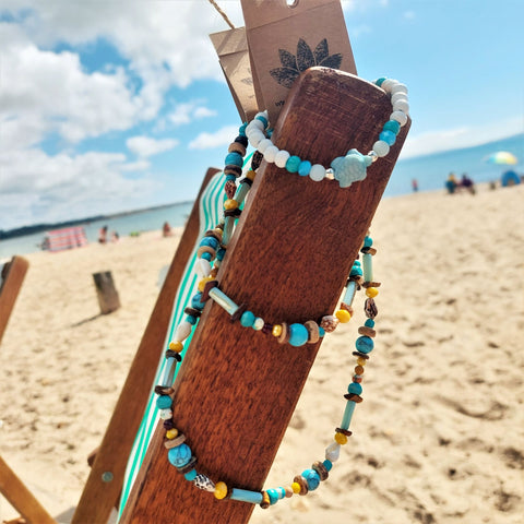 A super cool long bead surf necklace in lovely blue, yellow &amp; brown colours. A Perfect addition to all your Summer outfits.

A combination of natural stone, shell, calcite, wood &amp; silver hematite beads&nbsp;

Silver plated fastenings &amp; clasp&nbsp;with silver (nickel free) 'made with love' heart &amp; little turtle charm

length 74cm

Gift wrapped &amp; presented in a pretty organza pouch