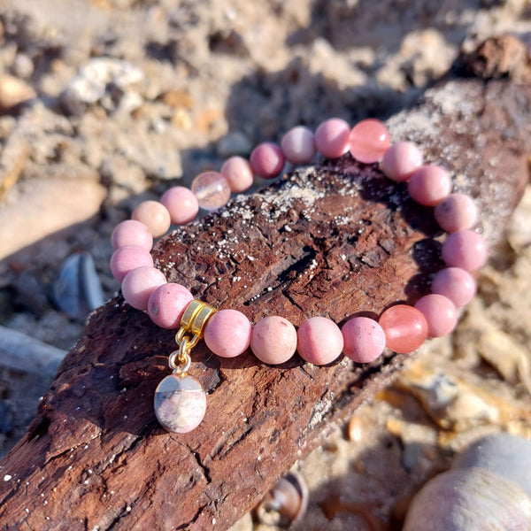 8mm Deep Pink Matt Rhodonite stone bead bracelet with gorgeous gold plated charm Elasticated, so will fit most adult wrists (measuring 71/2 in/19cm) Lovely gift for friends or family **Presented in lovely Kraft paper gift box with reusable organza pouch**
