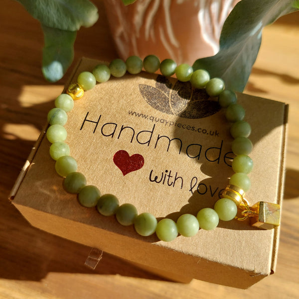 Lovely 6mm Matt Natural Serpentine Stone Bead Bracelet in olive green with Gold plated cube charm  Elasticated, so will fit most adult wrists (measuring 71/2 in/19cm)  Perfect for wearing with those Winter outfits & a lovely gift for friends or family  **Presented in lovely Kraft paper gift box with reusable organza pouch**