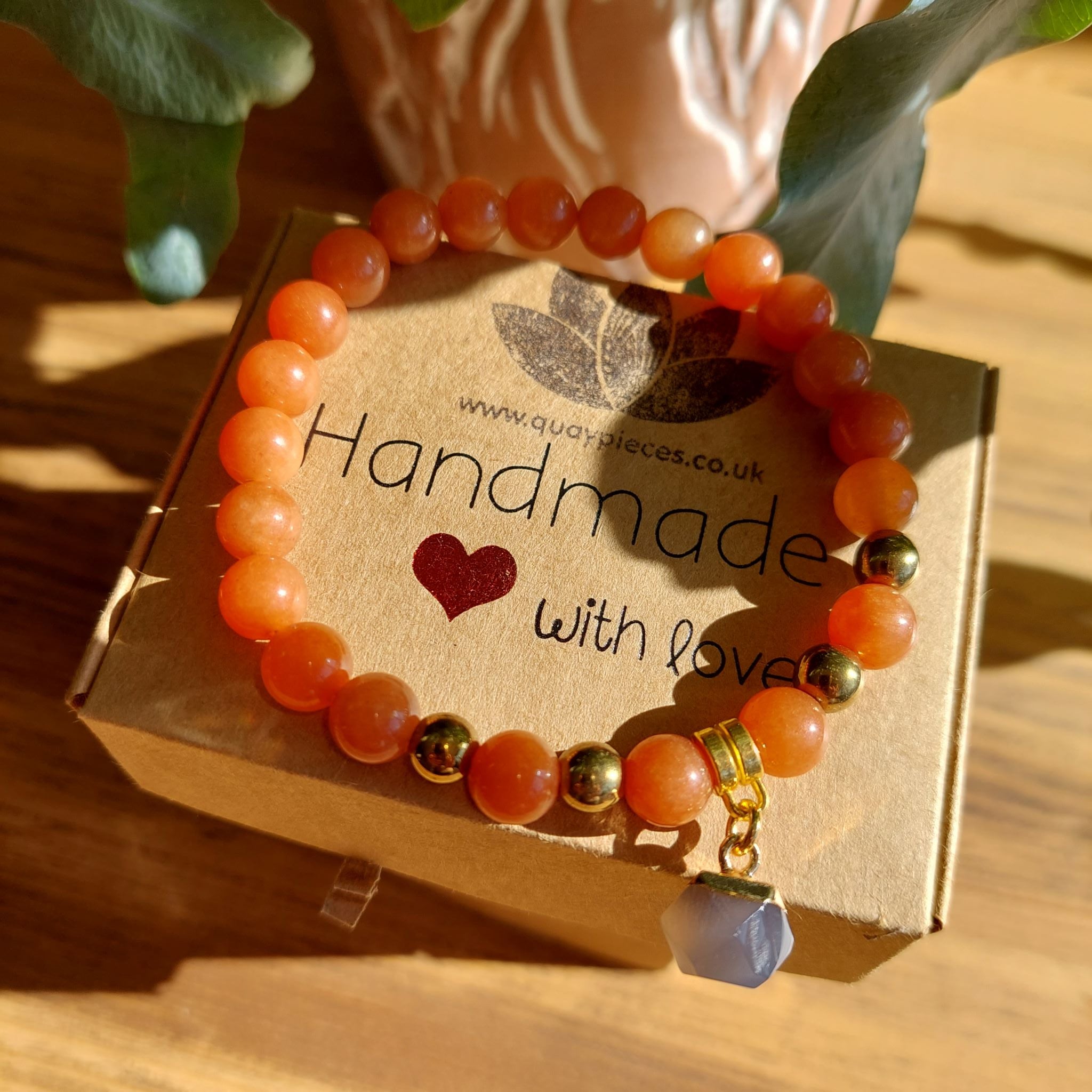 Gorgeous handmade 8mm deep orange natural stone quartz beaded bracelet with gold plated dark grey hexagon natural stone charm  ﻿Elasticated, so will fit most adult wrists (measuring 71/2 in/19cm)  Lovely gift for friends or family  **Presented in lovely Kraft paper gift box with reusable organza pouch**
