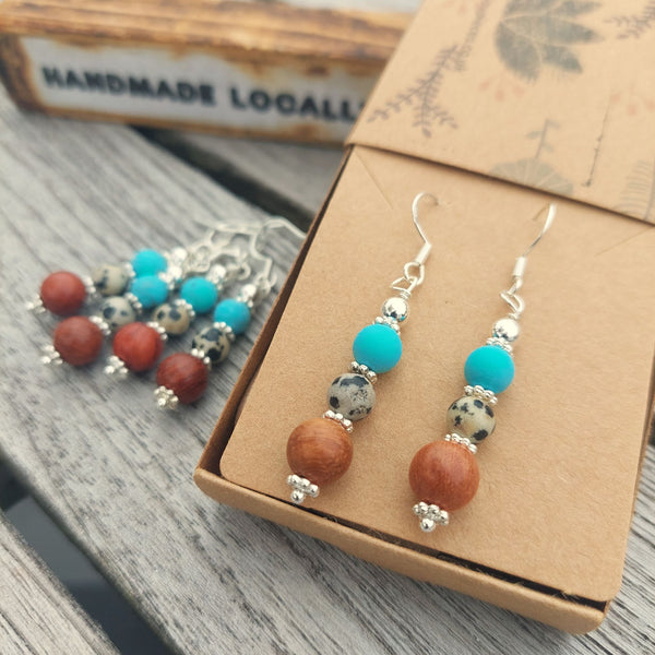<p>Lovely ethnic style earrings with wood, dalmatian jasper, turquoise beads &amp; silver discs</p> <p>925 Sterling Silver Hook</p> <p>Length 35mm from bottom of hook</p> <p>Sweet little gift for family &amp; friends!</p> <p><strong><em>**Presented in lovely Kraft paper gift box with reusable organza pouch**</em></strong></p>
