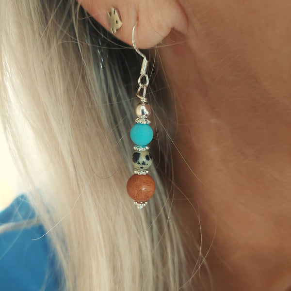 <p>Lovely ethnic style earrings with wood, dalmatian jasper, turquoise beads &amp; silver discs</p> <p>925 Sterling Silver Hook</p> <p>Length 35mm from bottom of hook</p> <p>Sweet little gift for family &amp; friends!</p> <p><strong><em>**Presented in lovely Kraft paper gift box with reusable organza pouch**</em></strong></p>