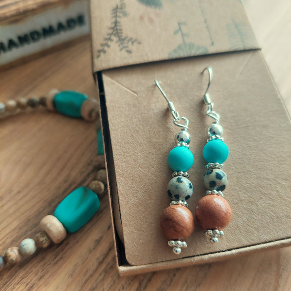 <p>Lovely ethnic style earrings with wood, dalmatian jasper, turquoise beads &amp; silver discs</p> <p>925 Sterling Silver Hook</p> <p>Length 35mm from bottom of hook</p> <p>Sweet little gift for family &amp; friends!</p> <p><strong><em>**Presented in lovely Kraft paper gift box with reusable organza pouch**</em></strong></p>