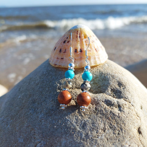 <p>Lovely ethnic style earrings with wood, dalmatian jasper, turquoise beads &amp; silver discs</p> <p>925 Sterling Silver Hook</p> <p>Length 35mm from bottom of hook</p> <p>Sweet little gift for family &amp; friends!</p> <p><strong><em>**Presented in lovely Kraft paper gift box with reusable organza pouch**</em></strong></p>