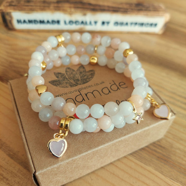 Gorgeous quartz bead bracelet in creamy ivory & peach tones with gold plated charms & stone heart ﻿  Elasticated, so will fit most adult wrists (measuring 7.5in/19cm)  Perfect for wearing stacked or solo with your winter outfits!  **Presented in lovely Kraft paper gift box with reusable organza pouch**