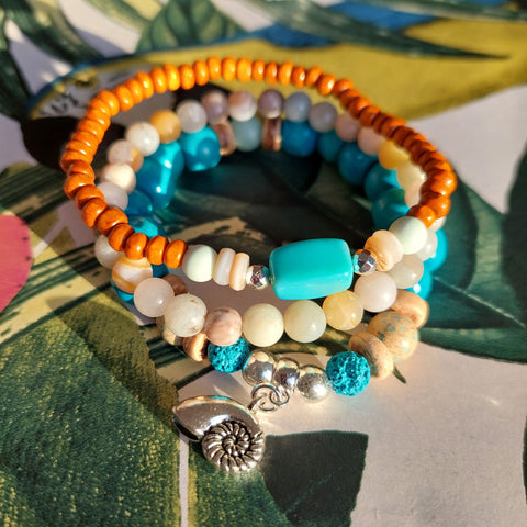 <p data-mce-fragment="1">Handcrafted Collection of 3 Wood &amp; Stone Beaded Bracelets</p> <p data-mce-fragment="1">Each Bracelet is individually designed, (1) 8mm turquoise wood &amp; aqua green stone beads, coconut discs, &amp; spiral shell charm (nickel free), (2) 6mm multicolour aqua agate stone beads plus (3) 4mm orange wood beads with shell discs &amp; silver plated hematite beads</p> <p data-mce-fragment="1">Elasticated, so will fit most adult wrists (measuring 7.5 in/19cm)</p>
