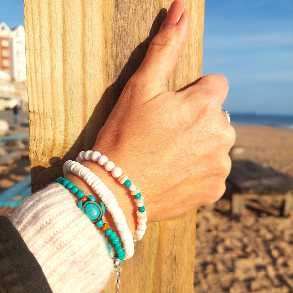 Handcrafted Collection of 3 Beaded Bracelets

Each Bracelet is individually designed, (1) white puka shell discs (2) white marble stone &amp; shell discs with turquoise beads (3) turquoise howlite beads with turtles

Elasticated, so will fit most adult wrists (measuring 7.5 in/19cm)

Wear altogether or separately for a boho/Surf Chick look!