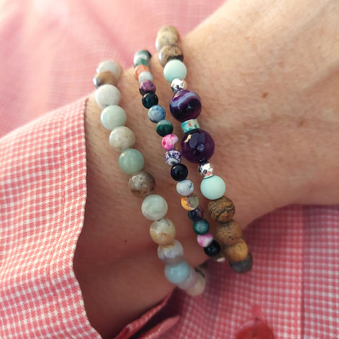<p data-mce-fragment="1">Handcrafted Collection of 3 Natural Stone Beaded Bracelets</p> <p data-mce-fragment="1">Each Bracelet is individually designed, (1) 6mm multi aqua colour natural stone quartz beads (2) 6mm brown matt natural stone beads with purple agate, mint &amp; silver plated hematite beads plus (3) 4mm multicolour agate beads</p> <p data-mce-fragment="1">Elasticated, so will fit most adult wrists (measuring 7.5 in/19cm)</p>