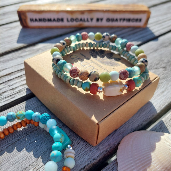 Handcrafted Collection of 2 Wood &amp; Stone Beaded Bracelets  Each Bracelet is individually designed with a combination of 6mm &amp; 4mm wood, stone, shell, lava &amp; silver plated beads.   Choose from 2 colourways Blue/orange or Green/brown  Elasticated, so will fit most adult wrists (measuring 7.5 in/19cm)