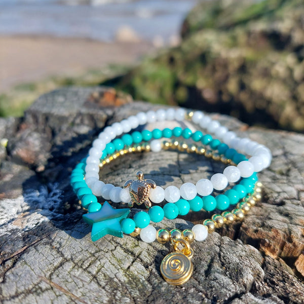 <p data-mce-fragment="1">Gorgeous Handcrafted Collection of 3 Delicate Beaded Bracelets</p> <p data-mce-fragment="1">Each Bracelet is individually designed, (1) 4mm natural white jade beads with cute 18k gold plated turtle (2) 4mm turquoise magnesite beads with star (3) 4mm 18k gold plated beads with hanging swirl charm</p> <p data-mce-fragment="1">Wear altogether or separately for a boho/Surf Chick look!</p>