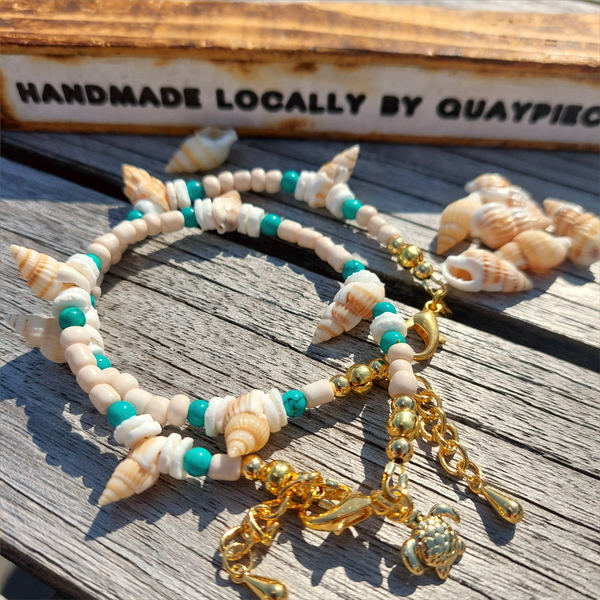 Gorgeous delicate bracelet, great for stacking or wear alone for a beach look!  Ivory seed beads, turquoise calcite, puka shells &amp; little spiral shells  Each bracelet has gold plated fastenings &amp; lobster clasp with super cute turtle charm &amp; extension chain  Lenght 20cm extending to 23cm&nbsp;  Perfect gift for any surf chick!
