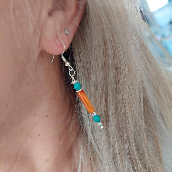 Lovely ethnic style earrings handmade with orange shell tubes, turquoise &amp; separated with silver plated flower discs &amp; beads

925 Sterling Silver Hook

Length 35mm from bottom of hook

Add a bit of colour to your day!