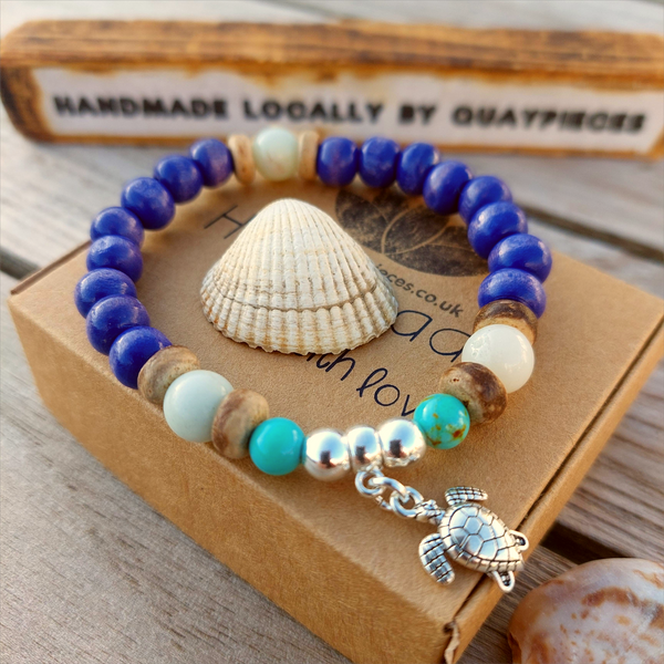 Fun sea creature bracelets, handmade with wood, ceramic &amp; stone beads, coconut discs &amp; silver plated beads charms

Elasticated, so will fit most adult wrists (measuring 7.5 in/19cm)

Each bracelet may be slightly different.

Great little gift to make someone's day or cheer up a friend!

**Presented in lovely Kraft paper gift box with reusable organza pouch**
