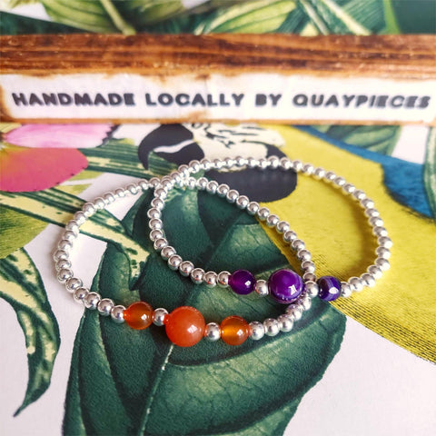 Add a touch of elegance to your outfit with these stunning 4mm handmade Sterling Silver bead bracelets. Choose from vibrant Purple or warm Amber Agate beads. These versatile bracelets can be worn alone or stacked for a fun and stylish look! With its elastic band, it can easily fit on most adult wrists, measuring 7.5 inches or 19 centimeters. Each bracelet comes in a lovely Kraft paper gift box with a reusable organza pouch, &amp; silver polishing square, making it the perfect gift for yourself or a loved on