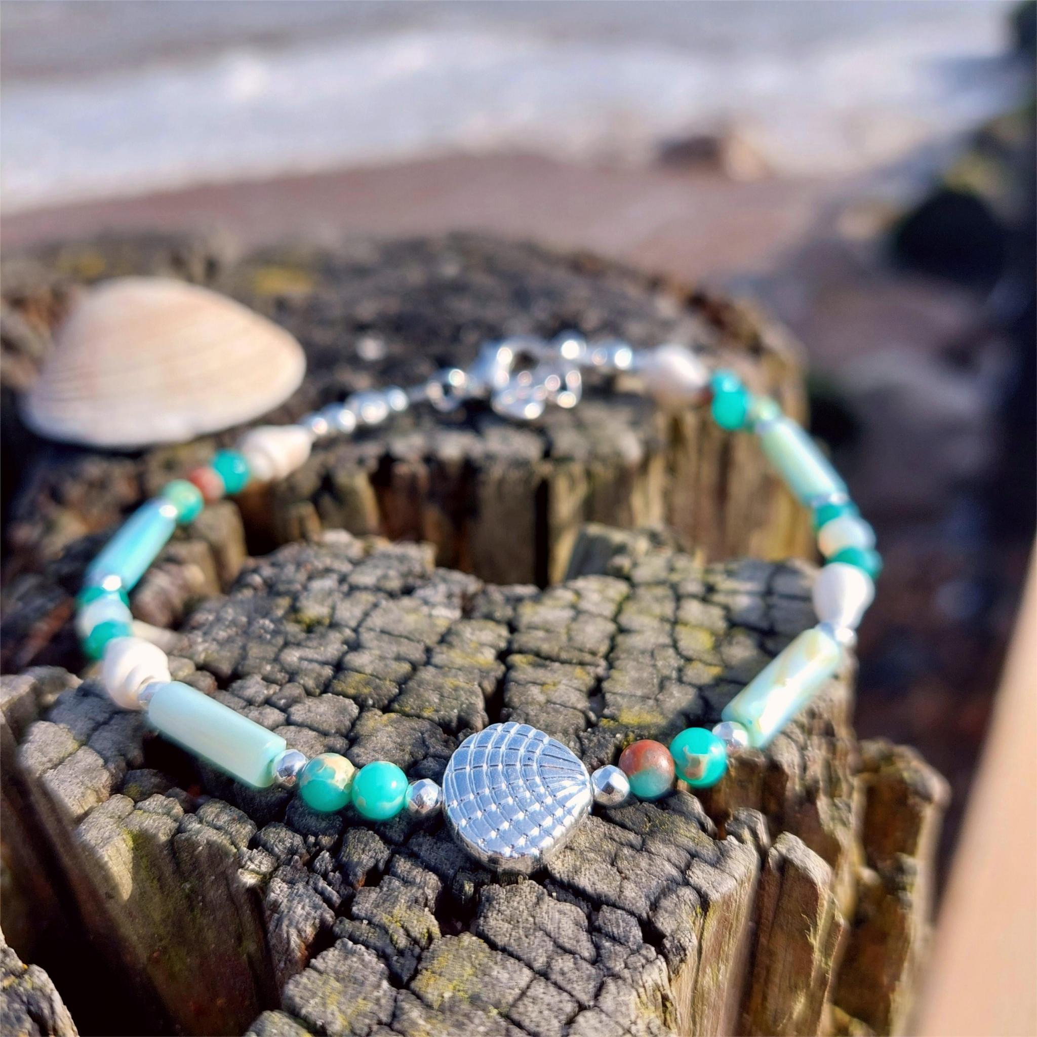 Put your best foot forward on the beach!

Super cute beach anklet, handmade with white spiral shells &amp; green marble effect natural stone beads, silver hematite &amp; aqua shell tubes with silver plated shell

Each anklet has sterling silver plated fastenings, lobster clasp &amp; turtle &amp; starfish (nickel free) charm

Each anklet has sterling silver plated fastenings, lobster clasp &amp; made with extension chain to adjust the length.

Length - 24cm extends to 27cm