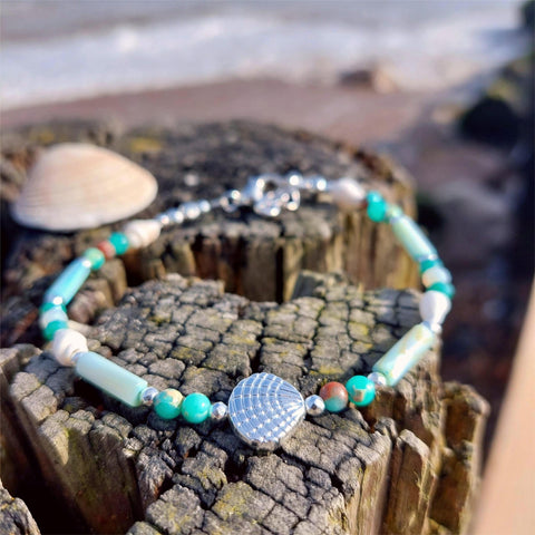 Put your best foot forward on the beach!

Super cute beach anklet, handmade with white spiral shells &amp; green marble effect natural stone beads, silver hematite &amp; aqua shell tubes with silver plated shell

Each anklet has sterling silver plated fastenings, lobster clasp &amp; turtle &amp; starfish (nickel free) charm

Each anklet has sterling silver plated fastenings, lobster clasp &amp; made with extension chain to adjust the length.

Length - 24cm extends to 27cm