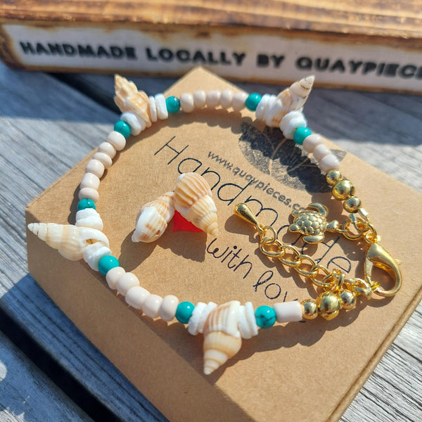 Gorgeous delicate bracelet, great for stacking or wear alone for a beach look!  Ivory seed beads, turquoise calcite, puka shells &amp; little spiral shells  Each bracelet has gold plated fastenings &amp; lobster clasp with super cute turtle charm &amp; extension chain  Lenght 20cm extending to 23cm&nbsp;  Perfect gift for any surf chick!