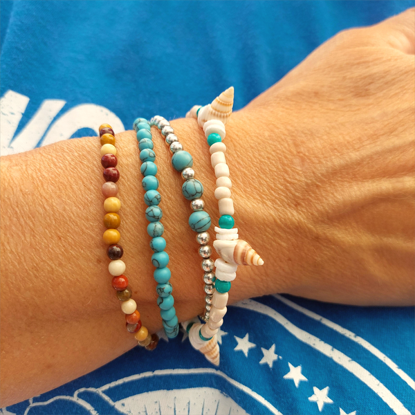Gorgeous delicate bracelet, great for stacking or wear alone for a beach look!  Ivory seed beads, turquoise calcite, puka shells &amp; little spiral shells  Each bracelet has gold plated fastenings &amp; lobster clasp with super cute turtle charm &amp; extension chain  Lenght 20cm extending to 23cm&nbsp;  Perfect gift for any surf chick!