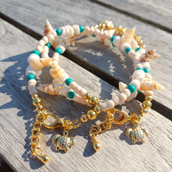 Gorgeous delicate bracelet, great for stacking or wear alone for a beach look!  Ivory seed beads, turquoise calcite, puka shells &amp; little spiral shells  Each bracelet has gold plated fastenings &amp; lobster clasp with super cute turtle charm &amp; extension chain  Lenght 20cm extending to 23cm&nbsp;  Perfect gift for any surf chick!