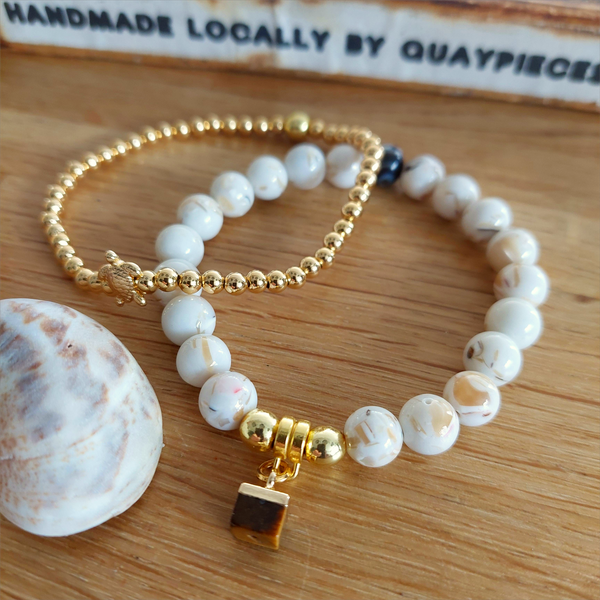 Lovely cream marble effect 8mm stone beads with coffee colour stone cube &amp; gold plated hematite beads.

Each bracelet will be unique due to varying colour shades of the stone beads

Elasticated, so will fit most adult wrists (measuring 71/2 in/19cm)

**Presented in lovely Kraft paper gift box with reusable organza pouch**