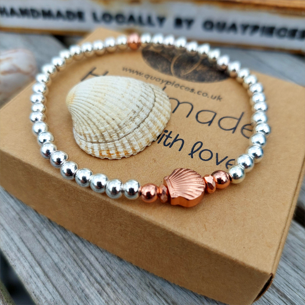 Silver plated &amp; rose gold hematite bead bracelet with pretty shell charm&nbsp;

Elasticated, so will fit most adult wrists (measuring 7.5 in/19cm)

Super cute simple bracelet to wear alone or as a stack!

**Presented in lovely Kraft paper gift box with pretty reusable organza pouch**