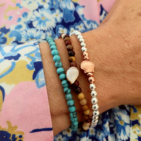 Silver plated &amp; rose gold hematite bead bracelet with pretty shell charm&nbsp;

Elasticated, so will fit most adult wrists (measuring 7.5 in/19cm)

Super cute simple bracelet to wear alone or as a stack!

**Presented in lovely Kraft paper gift box with pretty reusable organza pouch**