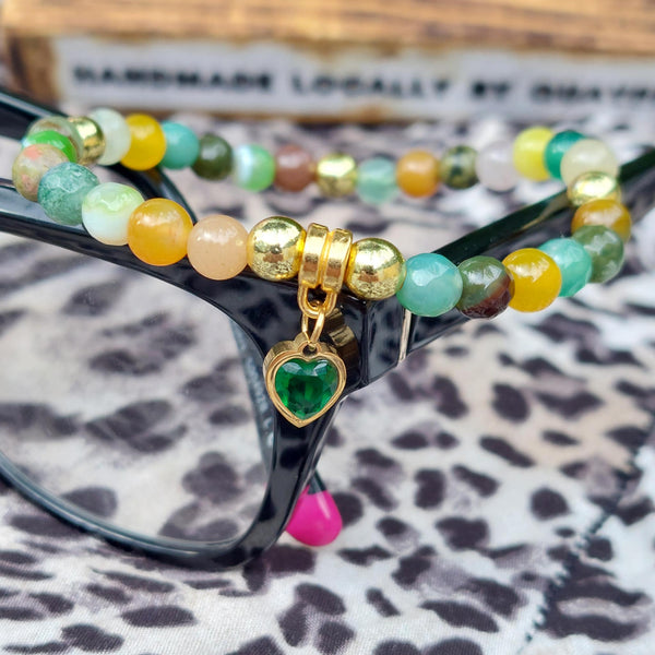 Lovely Handmade 6mm gemstone bracelet with agate, glass &amp; gold plated beads in seasonal multicolour greens &amp; ambers with a gorgeous dark green cubic zirconia heart charm.



Elasticated, so will fit most adult wrists (measuring 7.5in/19cm)


A great addition to your winter outfits!

**Presented in lovely Kraft paper gift box with reusable organza pouch**

**To keep your quaypieces looking great, always take me off before showering or swimming. Avoid over stretching by rolling the bracelet on &amp; o