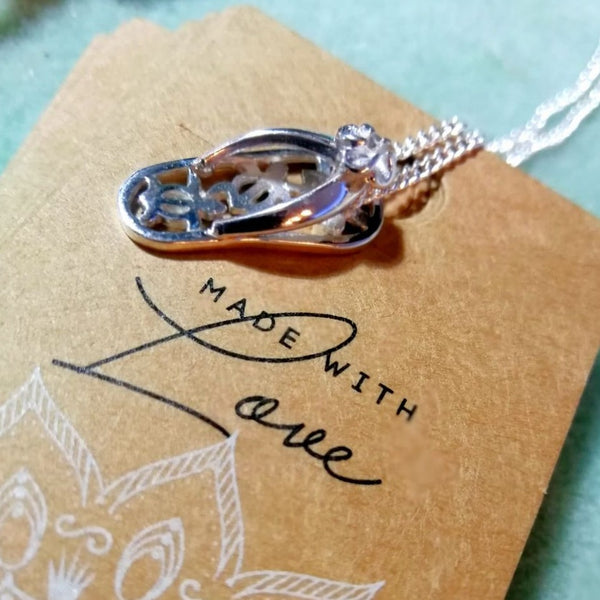 925 Hall Marked Sterling Silver  Adorable cut out turtle flip flop pendant  H 22 mm x W 10 mm   18" Silver 1 mm curb chain with lobster clasp  Great gift for any beach buddie!  **Presented in lovely Kraft paper gift box with reusable organza pouch**