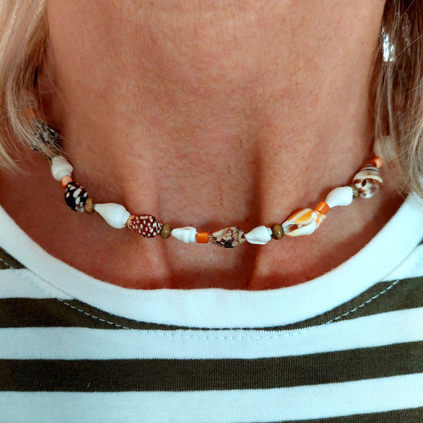 Dainty handmade natural shell, orange shell & wood beaded surf style choker necklace  Approximately 10mm coconut brown spiral shells & made with love charm  The necklace has sterling silver plated fastenings & lobster clasp with extension chain to adjust the length  Length - 40cm extends to 44cm  Cute little gift for any Surfer chick!   **Presented in lovely Kraft paper gift box with reusable organza pouch**  **To keep your quaypieces looking great, always take me off before showering or swimming**   