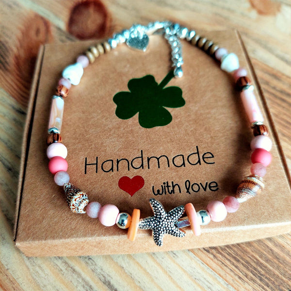 ﻿Put your best foot forward on the beach!  Cute handmade anklet with a combination of spiral shells, silver hematite, wood & stone beads with pink shell tubes & silver (nickel free) Starfish  Each anklet has sterling silver plated fastenings, lobster clasp & made with love heart charm with extension chain to adjust the length.  Length - 24cm extends to 27cm   **Presented in lovely Kraft paper gift box with reusable organza pouch**
