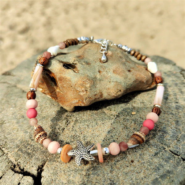 ﻿Put your best foot forward on the beach!  Cute handmade anklet with a combination of spiral shells, silver hematite, wood & stone beads with pink shell tubes & silver (nickel free) Starfish  Each anklet has sterling silver plated fastenings, lobster clasp & made with love heart charm with extension chain to adjust the length.  Length - 24cm extends to 27cm   **Presented in lovely Kraft paper gift box with reusable organza pouch**