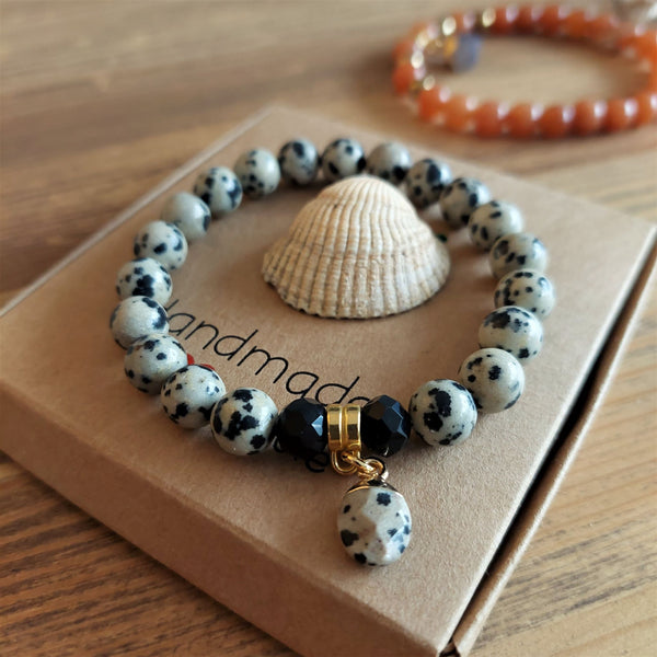 Lovely Dalamatian Jasper stone 8mm bead bracelet with gold plated charm   Elasticated, so will fit most adult wrists (measuring 71/2 in/19cm)  Perfect for wearing with those Christmas outfits & lovely gift for friends or family  **Presented in lovely Kraft paper gift box with reusable organza pouch**