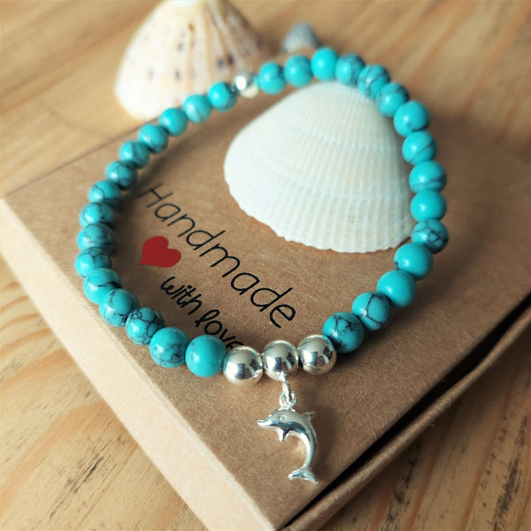 ﻿Lovely 6mm natural calcite stone beads in turquoise with sterling silver beads & dolphin charm  Elasticated, so will fit most adult wrists (measuring 71/2 in/19cm)  Super cute bracelet to wear alone or as a stack!  Presented in lovely Kraft paper gift box with pretty reusable organza pouch  **Will not tarnish if cared for properly**  **To keep your quaypieces looking great, always take me off before showering or swimming. Avoid over stretching by rolling the bracelet on & off your wrist**  ﻿