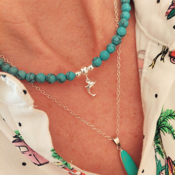 Gorgeous turquoise natural calcite stone bead necklace with sterling silver beads & cute  dolphin plus sterling silver toggle fastening.   Length - 42cm  A lovely addition to all those summer outfits & Super cute gift for any beach lover!