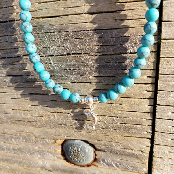 Gorgeous turquoise natural calcite stone bead necklace with sterling silver beads & cute  dolphin plus sterling silver toggle fastening.   Length - 42cm  A lovely addition to all those summer outfits & Super cute gift for any beach lover!
