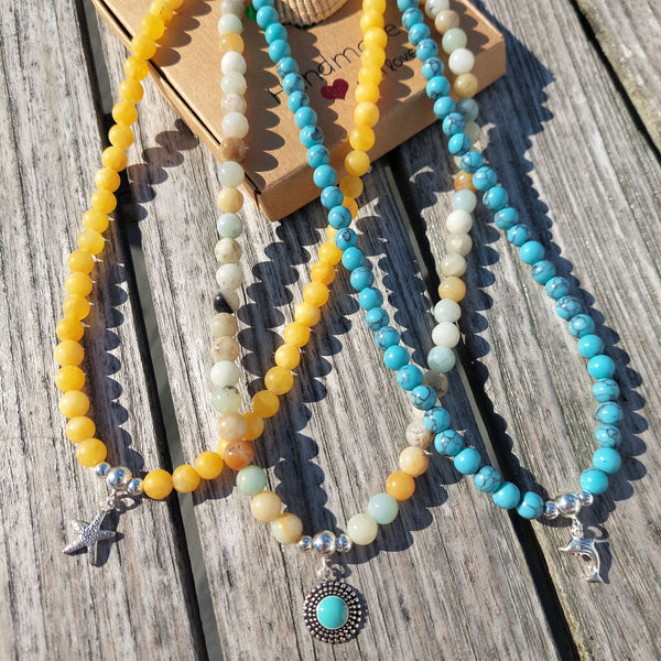 Gorgeous natural stone bead necklace with sterling silver beads & toggle fastening with choice of silver charm.  Length - 42cm  Choose from 1) Yellow beads with starfish                       2) Aqua/brown beads with turquoise circle  A lovely addition to all those summer outfits & Super cute gift for any beach lover!  **Presented in lovely Kraft paper gift box with reusable organza pouch**