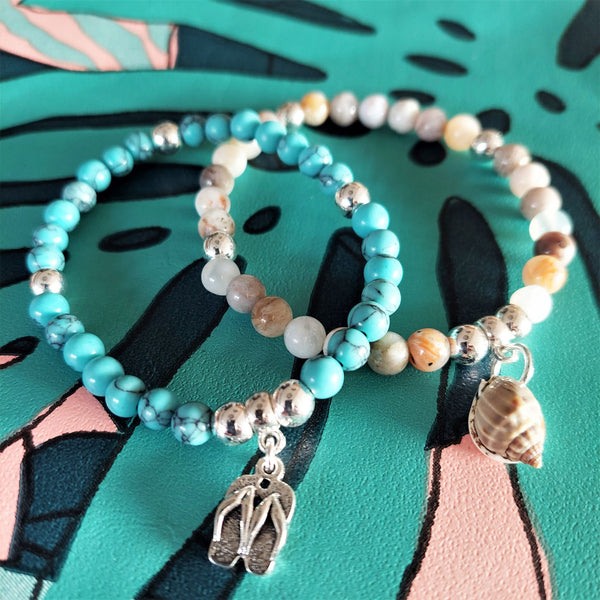 Lovely 6mm natural stone & silver plated hematite beads with a choice 2 designs   1) Grey, white tortoiseshell colour beads with natural shell  2) Turquoise calcite beads with flipflops (nickel free)  Elasticated, so will fit most adult wrists (measuring 71/2 in/19cm)  Add a cool beach vibe look to your outfit with these natural stone bracelets  **Presented in lovely Kraft paper gift box with reusable organza pouch**